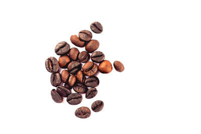 High angle view of coffee beans against white background