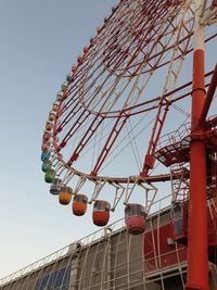 Low angle view of ferris wheel against sky