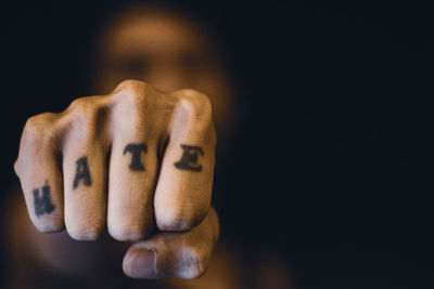 Close-up of human hand against black background