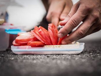 Close-up of person preparing food on table