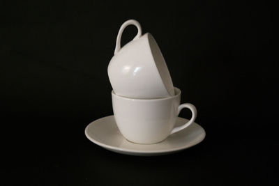Close-up of coffee cup against black background