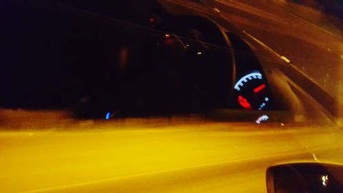 Close-up of illuminated car on road at night