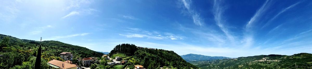 Panoramic view of mountains against blue sky