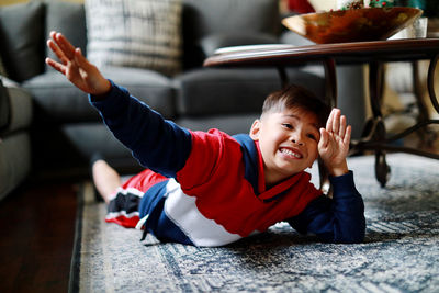 Portrait of smiling boy sitting in kitchen