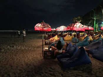 People at beach against sky