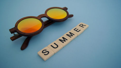 High angle view of information sign on table against blue background