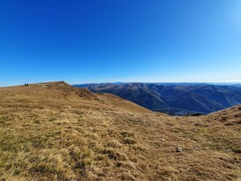 Scenic view of mountains against clear blue sky