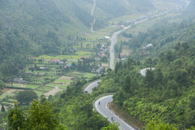 High angle view of road amidst trees and landscape