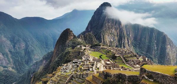 Panoramic view of mountains against cloudy sky