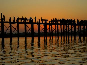 Pier on sea at sunset