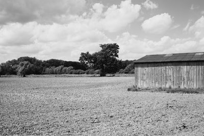 Barn on field against sky