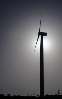 Low angle view of wind turbine against clear sky