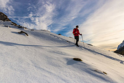 Full length of person on snowcapped mountain against sky