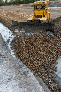 Earth mover at construction site against sky