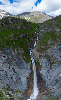 Low angle view of waterfall against sky