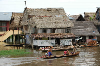 People on boat against building