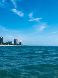 Scenic view of sea and buildings against sky