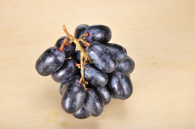 Close-up of grapes on wooden table