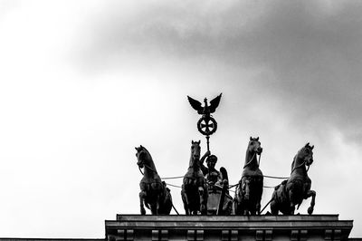 Low angle view of angel statue against sky