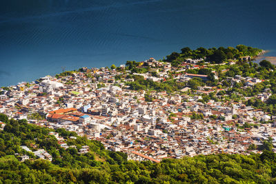 High angle view of townscape by sea