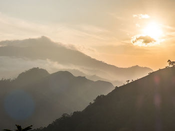 Scenic view of silhouette mountains against sky during sunset