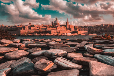 View of buildings and rocks at sunset