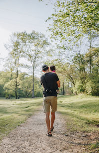 Rear view of friends walking on street