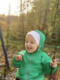 Portrait of cute boy smiling on land