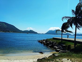 Scenic view of sea against clear blue sky