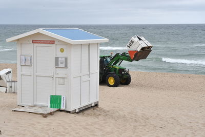 Lifeguard hut on beach against sky