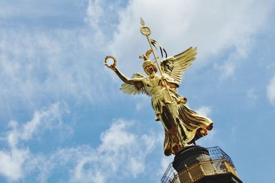 Low angle view of statue against cloudy sky