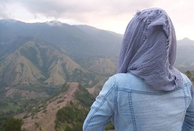 Scenic view of mountains against cloudy sky