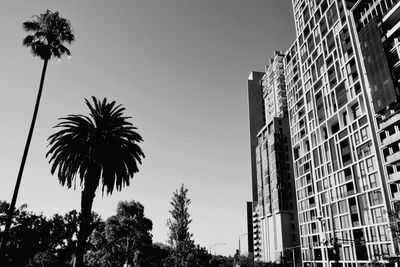 Low angle view of silhouette buildings against clear sky