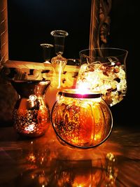 Close-up of lit candle in dark room