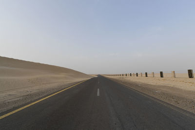 Road amidst landscape against clear sky