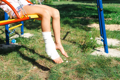 Low section of woman standing on grass