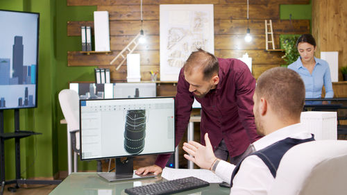 Side view of man working on table