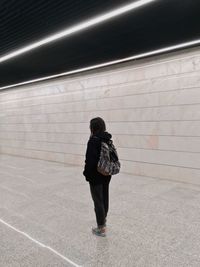 Rear view of woman walking in subway