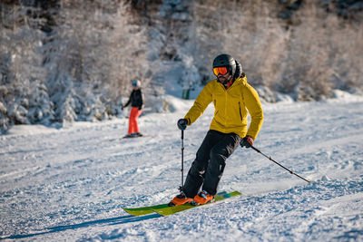 Man skiing on snow covered field