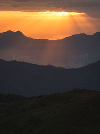 Scenic view of silhouette mountains against sky during sunset