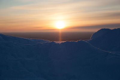 Snow with sun in background