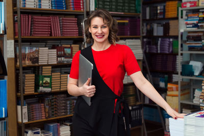 Professional woman educator or manager posing at public library of high school or college