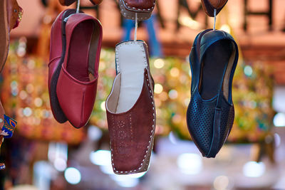 Close-up of shoes hanging at market stall