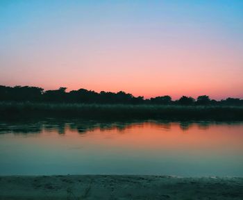 Scenic view of lake at sunset