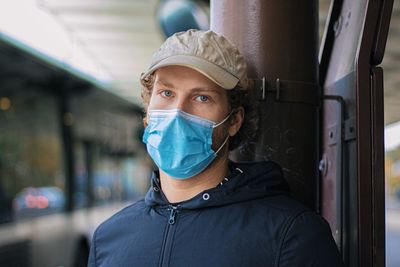 Portrait of young man wearing mask standing outdoors