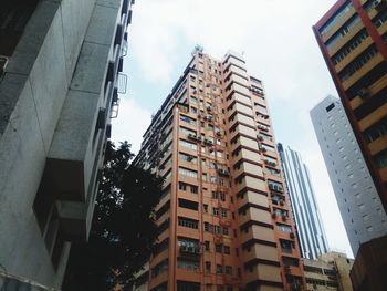 Low angle view of buildings in city against sky