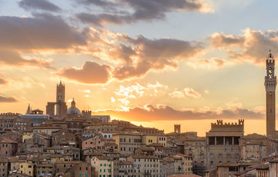 Town against sky during sunset