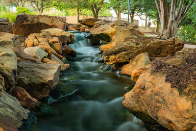 Stream flowing through rocks in forest