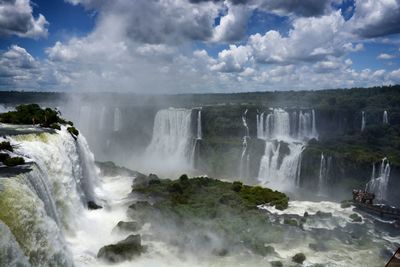 Scenic view of waterfall against sky