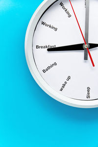 Close-up of clock over blue background